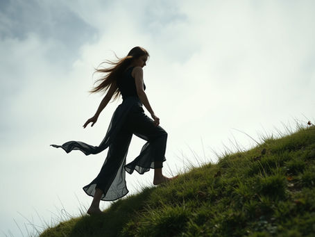 Woman walking up a grassy hill to her freedom and clarity