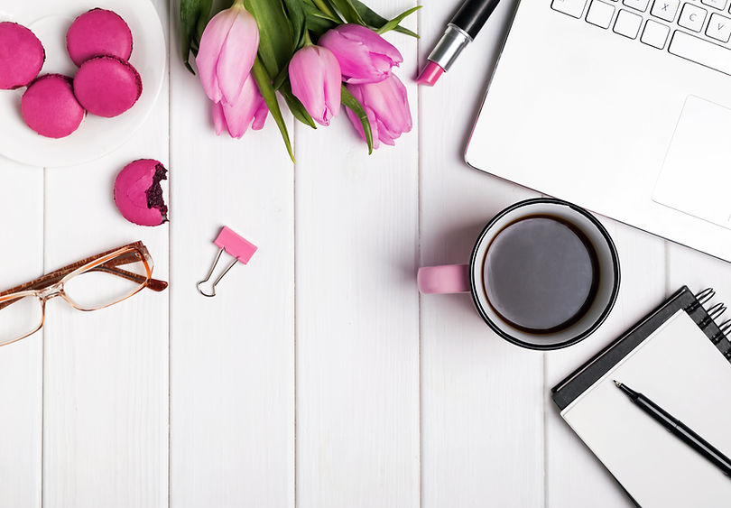 Woman's desktop with laptop, notepad, glasses, coffee and tulips.jpg