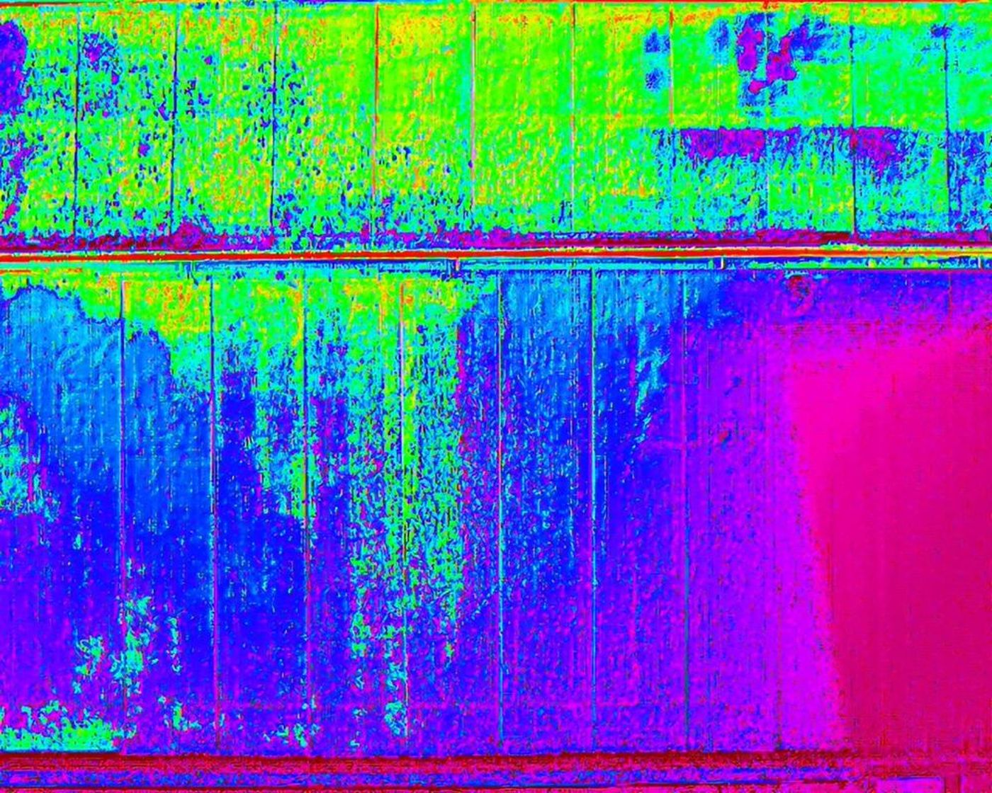 Thermal drone image of a flat roof with a cool purple zone where water is held