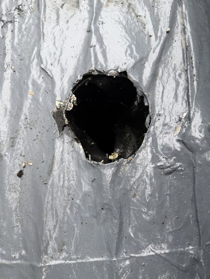 Gutter lining torn open around an outlet
