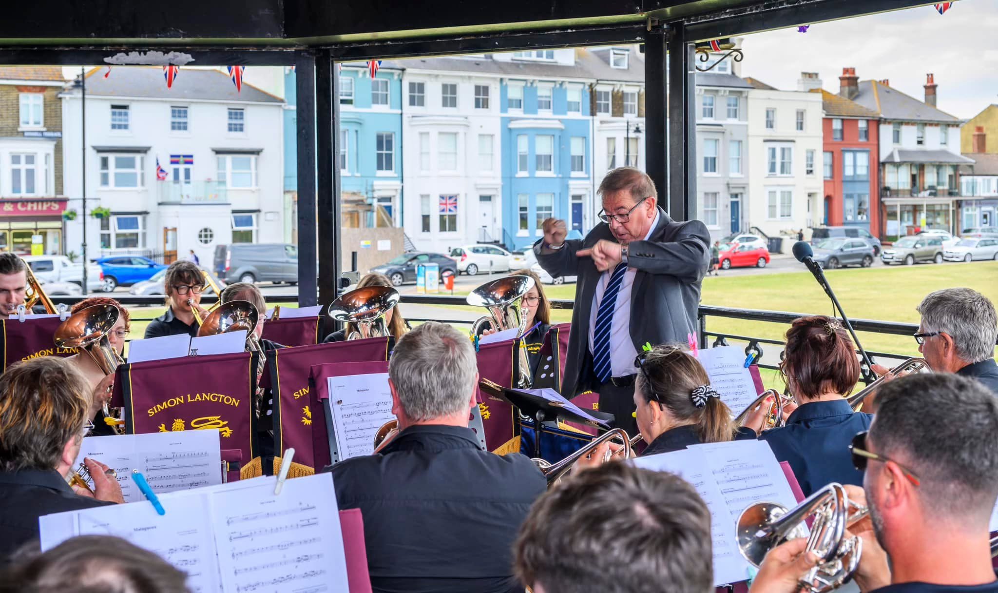 Andy Collins conducting Simon Langton Brass at an outdoor performance