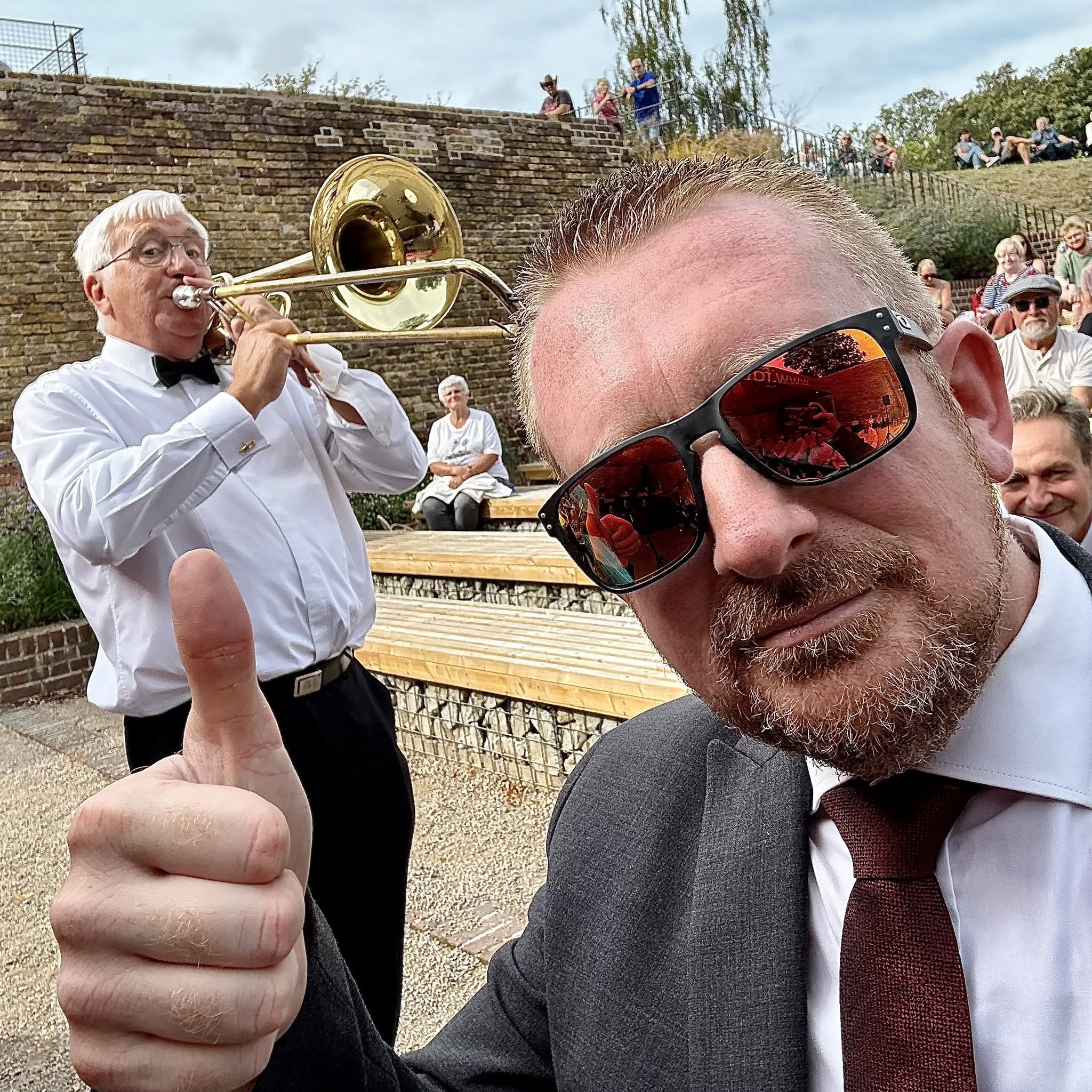 David Lockwood with a fellow brass musician at an outdoor performance