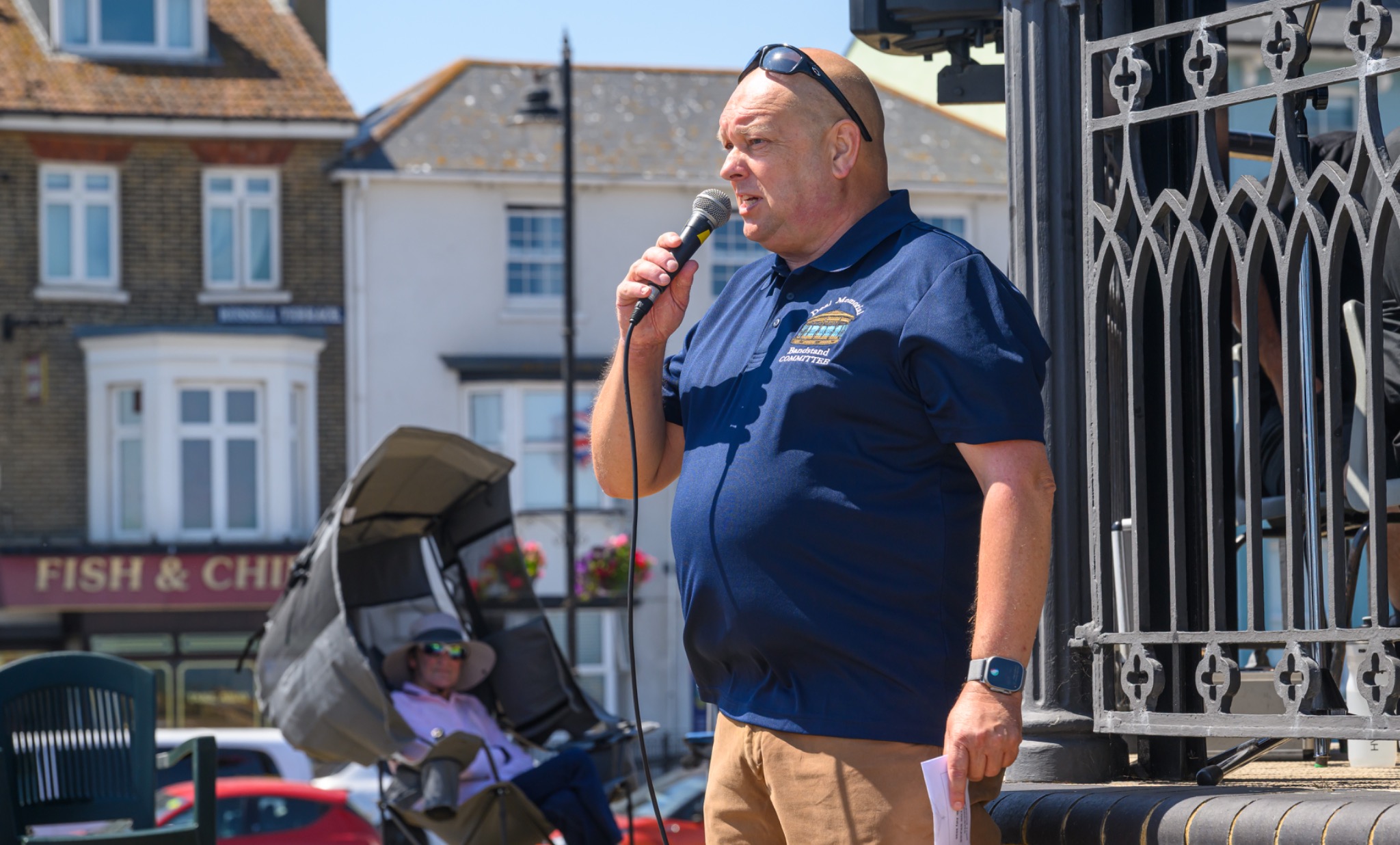 Bandstand compere speaking into a microphone at Deal