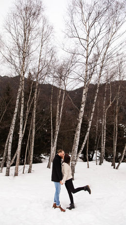 couple in snowy forest in switzerland after wedding proposal captured by wedding photographer Peace Love Leigh