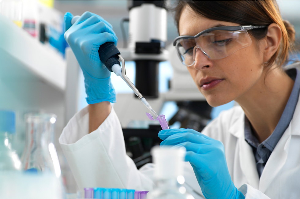 Scientist in lab coat and goggles uses pipette to transfer liquid into test tube. Microscope and lab equipment in background. Focused mood.
