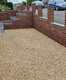 Driveway construction with capped pillars and gravel