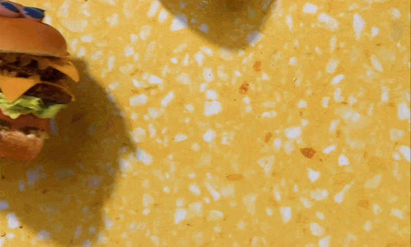 GIF of two hands toasting with vegan burgers, created for Follow Your Heart