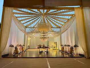 Draped tent hall with chandeliers for a wedding by Kauvery Events