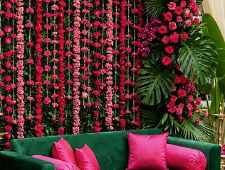 Rose wall with green sofa seating for mehndi by Kauvery Events