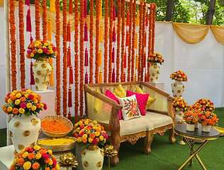 Marigold stage decoration for a haldi ceremony by Kauvery Events