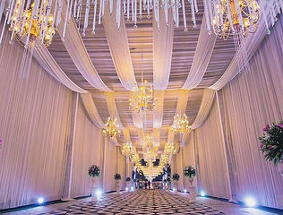 White draped walkway and chandelier entrance for a wedding by Kauvery Events