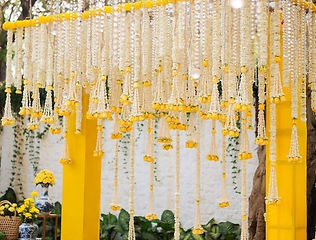 White and yellow flower string decoration by Kauvery Events