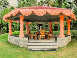 Outdoor gazebo mandap on a lawn by Kauvery Events