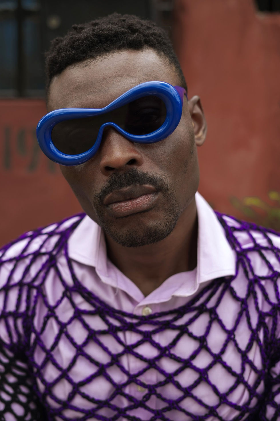 CLOSE UP OF ALTE MAN WITH SHADES (PURPLE BLUE)