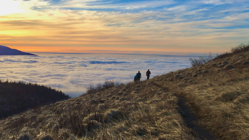 Hikers above the clouds