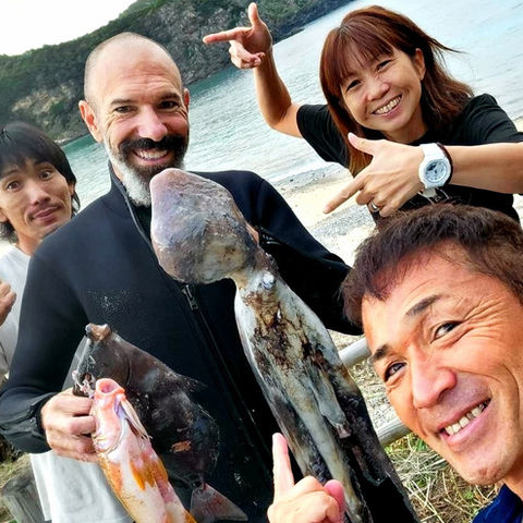 Guests with local fisherman after octopus catch