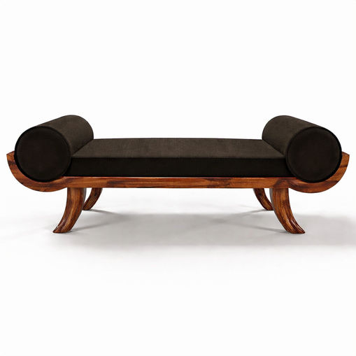 frontal view of the Curves daybed, showing its long low proportion, black velvet seat, rounded bolsters, and pau ferro wood structure.