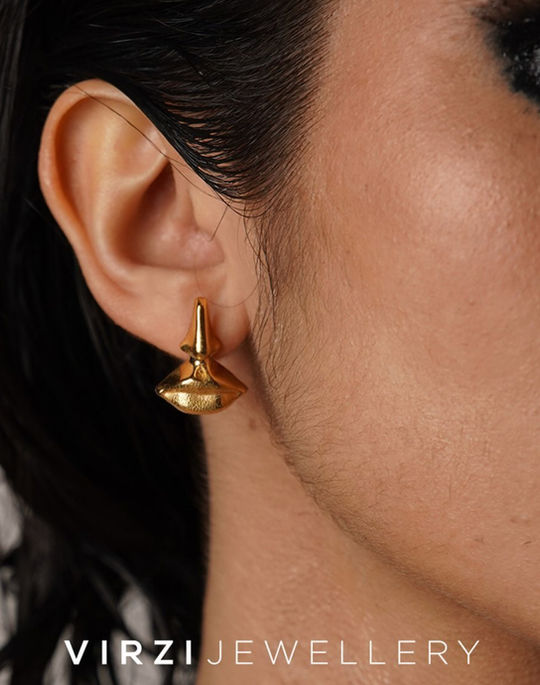 Front view of Surreal Earring in 18k gold-plated bronze shaped as a sculptural nose and lips
