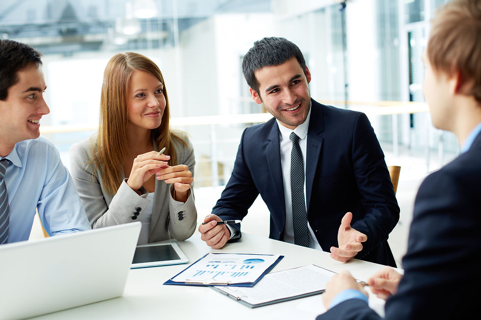 Image of business partners discussing documents and ideas at meeting.jpg