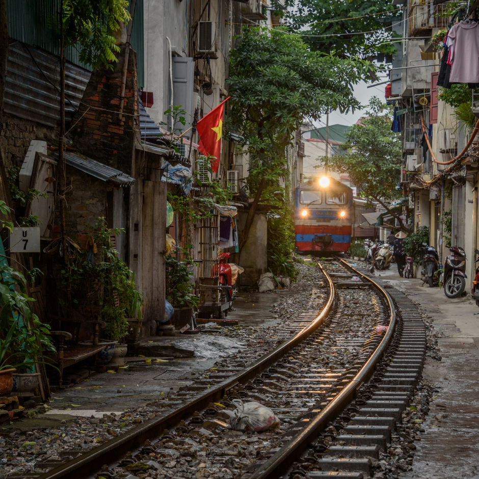 Hanoi Train Street with a train passing through narrow houses