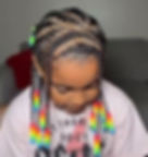 Child with cornrows and rainbow beaded braids