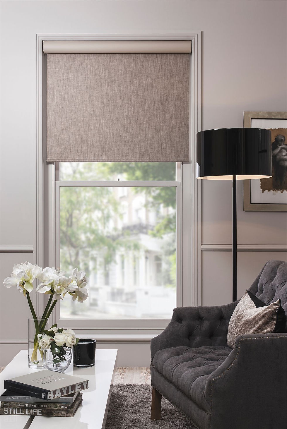 Simple and functional roller blind in a modern living room, offering easy light control and a clean, minimalist design that complements any interior style
