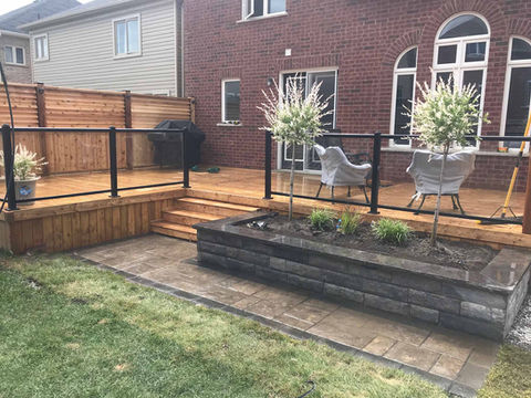 Custom Deck Build with Regal Railing including Glass. Retaining Wall for Garden and Interlock Design