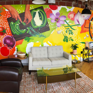 Collaboration between Red Swan and Marcella Kriebel. Interior office Mural for World Central Kitchen in Washington, DC. Food themed mural featuring fresh vegetables, herbs, and cooking. 