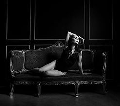black and white photo of woman sitting on couch