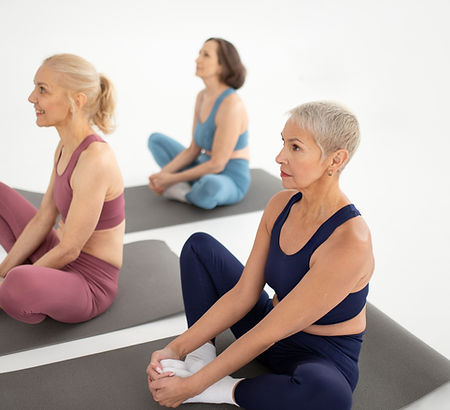 full-shot-women-sitting-yoga-mat.jpg