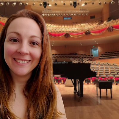 Music producer and composer Francesca Cadelano in a concert hall with a grand piano - Classical-Romantic style