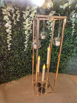 Tall gold geometric flower risers hire