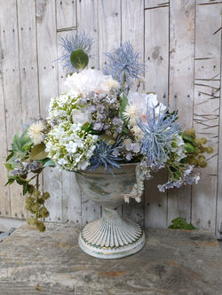 urn vase with flowers and foliage