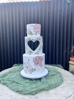 cut out heart wedding cakw with buttercream flower decoration