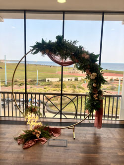 Gold moon gate with dusky pink fabric and florals