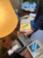 Detail of an actor using vintage props in an outdated messy office with blue and brown colors for an indie film shot in NYC.
