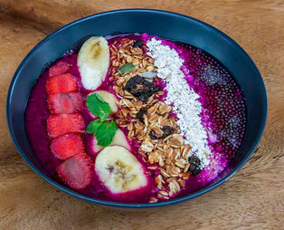 A vibrant tropical fruit platter featuring papaya, pineapple, and watermelon for surfers at The Ujung Bocur.