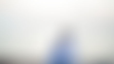 Father and daughter sitting together looking out at the water.