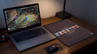 Digital deckbuilding game displayed next to physical trading cards showing the connection between digital and tabletop card games.