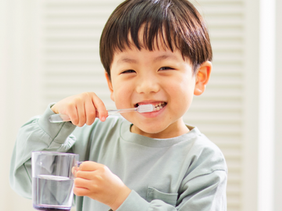 A boy brushing his teeth