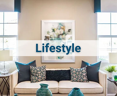 Contemporary blue and white couch below matching art and lit by sunlit windows