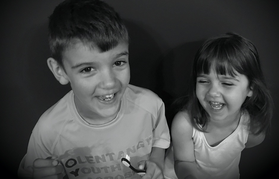 Happy kids brushing their teeth.