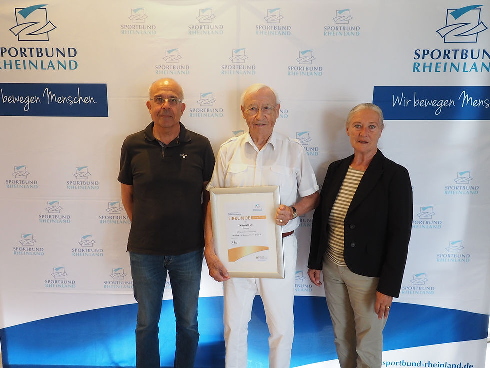 Paul Michels und Roland Moock (v.l.) nehmen die Ehrung von Monika Sauer, Geschäftsführerin des Sportbundes Rheinland, entgegen.