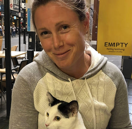Dr. Jenny Murphy sits with a dashing white and black cat on her lap.