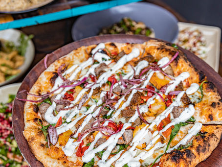 Delicious wood-fired gluten-free pizza at La Vita Mediterranean in Edensor Park, topped with fresh mozzarella, sun-ripened tomatoes, and Mediterranean herbs.