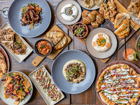A beautifully plated Mediterranean feast at La Vita Mediterranean in Edensor Park, featuring wood-fired pizza, grilled meats, fresh seafood, and traditional mezze dishes.