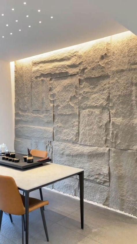 Space is elevated by a remarkable sandstone wall, showcasing detailed textures and gentle lighting, which together establish a natural and sophisticated atmosphere.