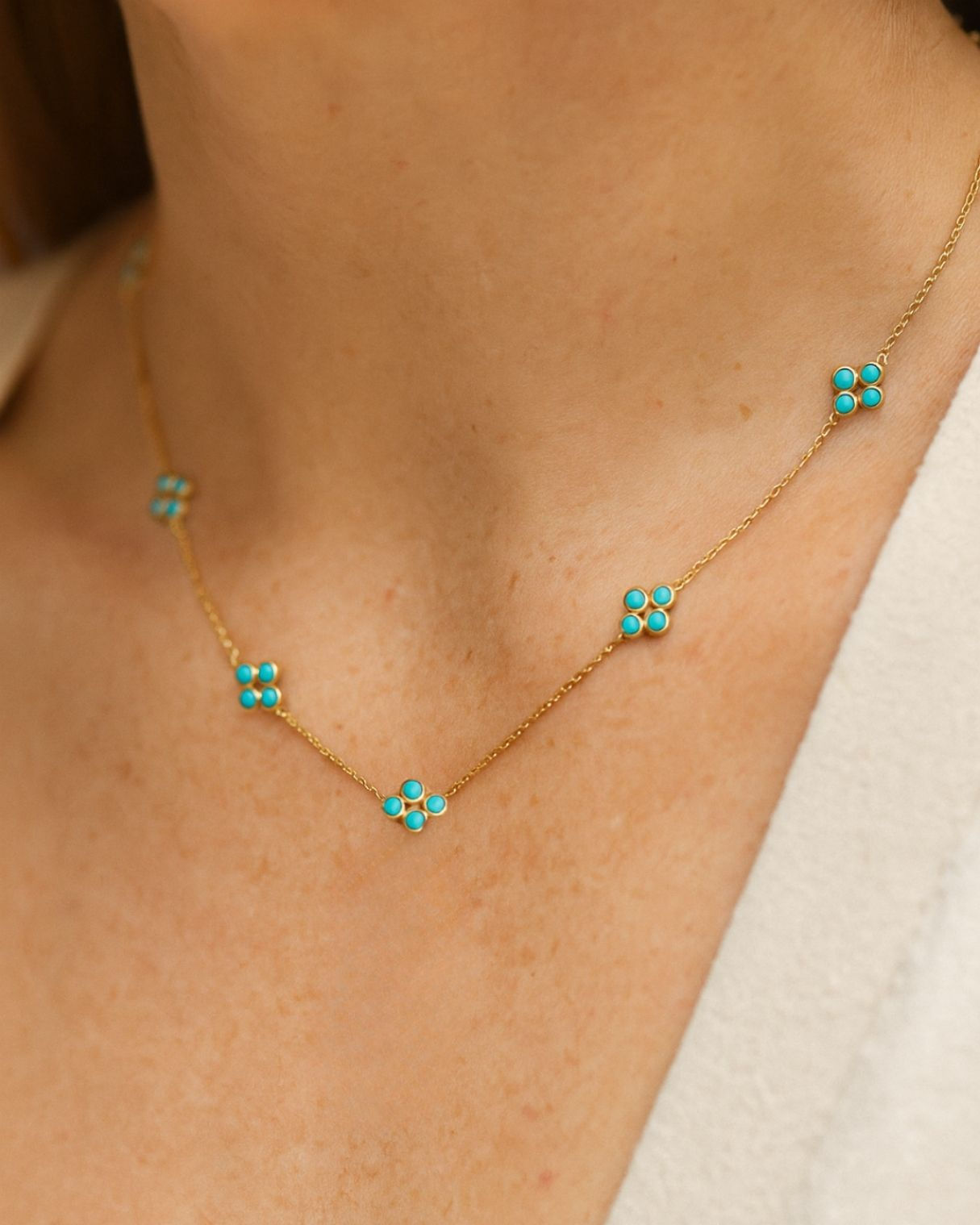 Dainty gold necklace with turquoise floral details