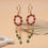 Thumbnail: Floral gemstone dangle earrings in 14k gold for women
