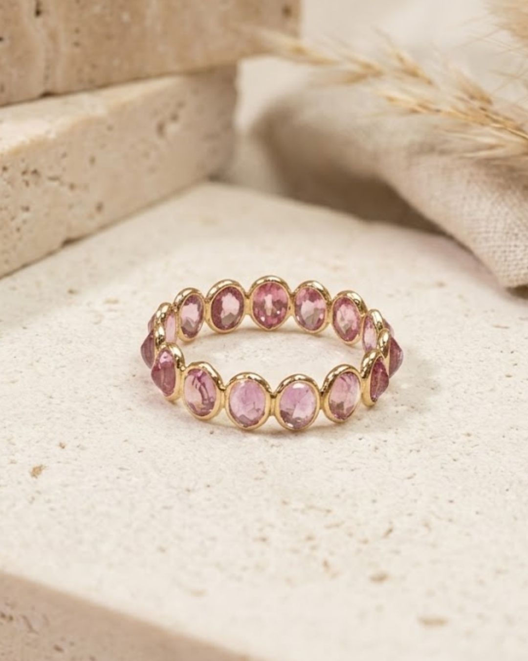 pink sapphire oval eternity ring in solid gold